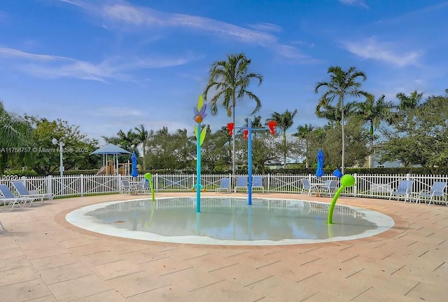 view of property's community with a patio, a pool, fence, and playground community