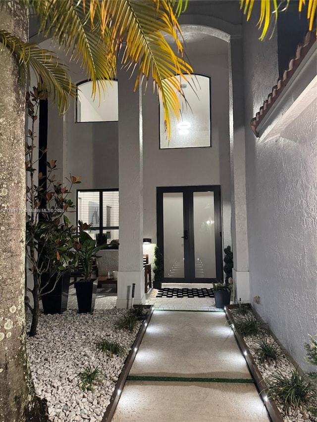 doorway to property with french doors and stucco siding