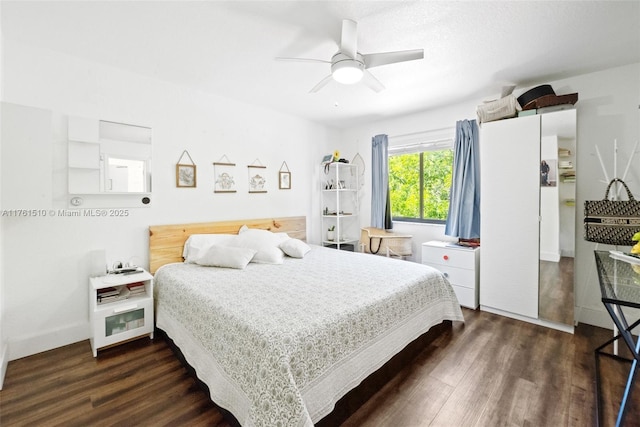 bedroom featuring dark wood finished floors and a ceiling fan