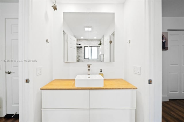 bathroom with vanity and wood finished floors