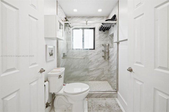 bathroom with a marble finish shower and toilet