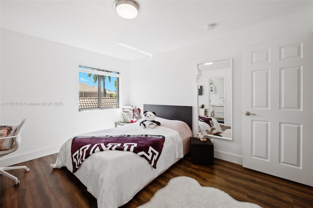 bedroom featuring baseboards and wood finished floors