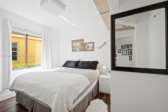 bedroom with dark wood-style flooring