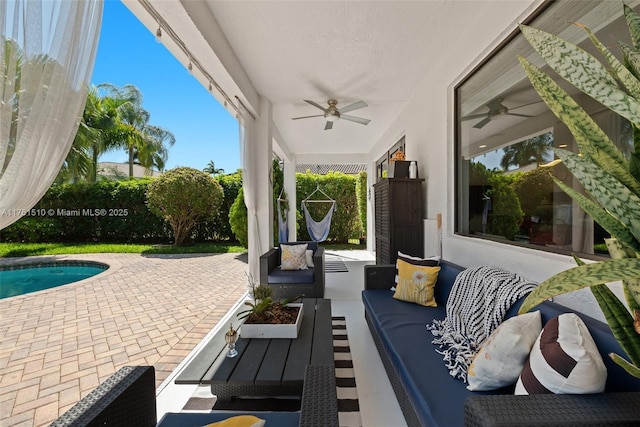 view of patio featuring a fenced in pool, outdoor lounge area, and a ceiling fan