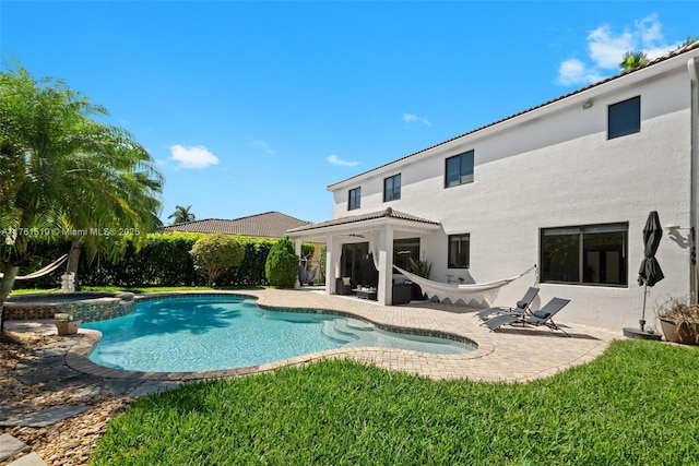 view of pool with a patio area and a pool with connected hot tub