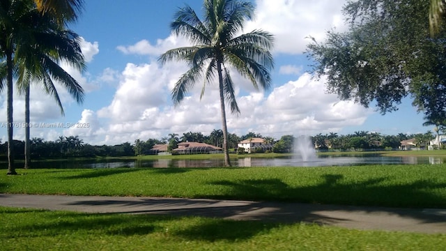 view of community featuring a yard and a water view