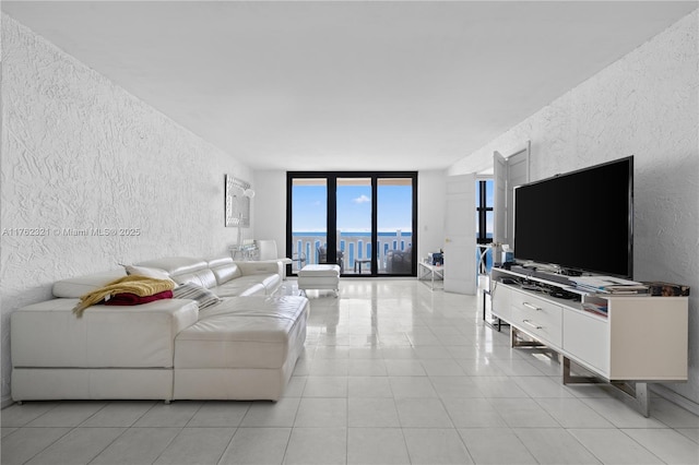 1111 Crandon Blvd Unit B506, Key Biscayne, FL 33149 - living room featuring a textured wall, expansive windows, and light tile patterned floors