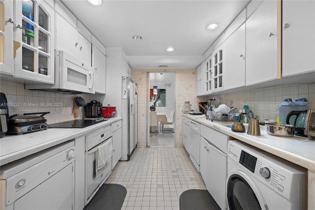 1111 Crandon Blvd Unit B506, Key Biscayne, FL 33149 - kitchen with washer / clothes dryer, white appliances, white cabinets, light countertops, and recessed lighting