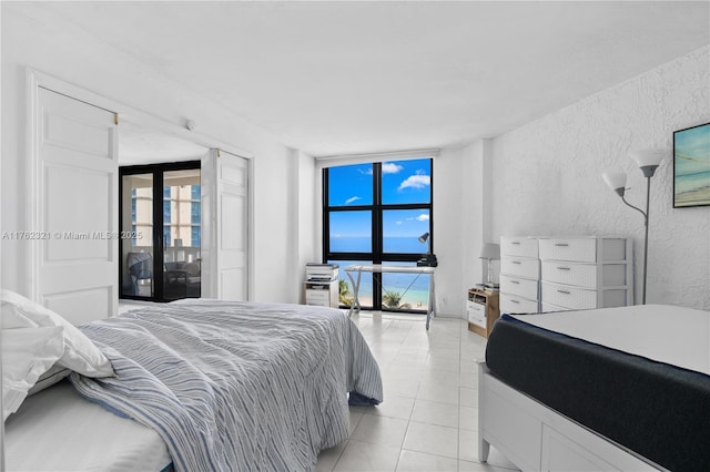 1111 Crandon Blvd Unit B506, Key Biscayne, FL 33149 - bedroom with multiple windows, a textured wall, and light tile patterned flooring