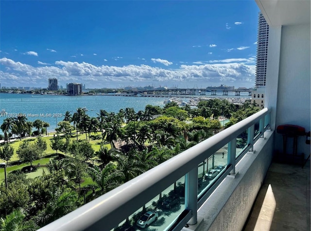 balcony with a water view and a city view