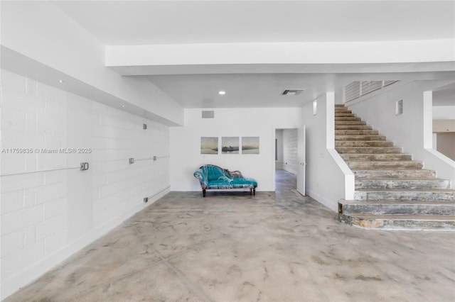 interior space with visible vents and concrete block wall