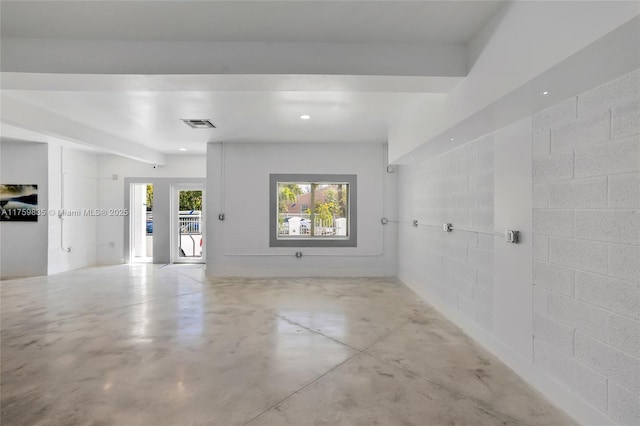 empty room with recessed lighting, visible vents, concrete floors, and concrete block wall