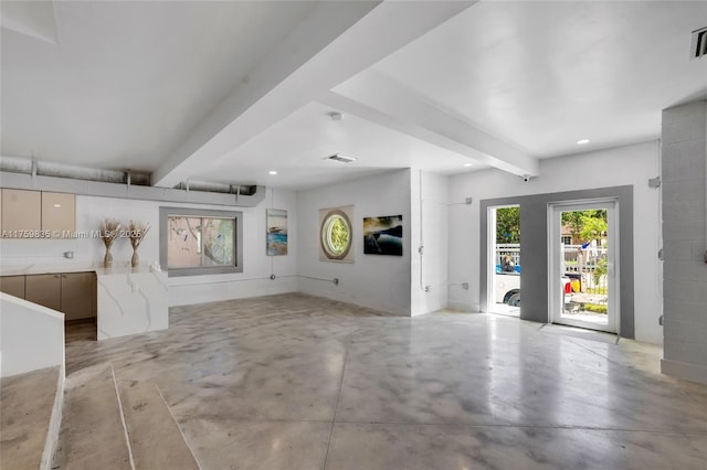 interior space featuring beam ceiling, visible vents, recessed lighting, and concrete floors