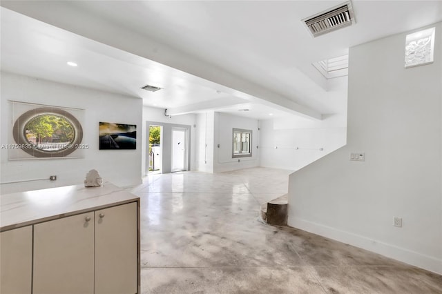 kitchen with visible vents, baseboards, beamed ceiling, and finished concrete flooring