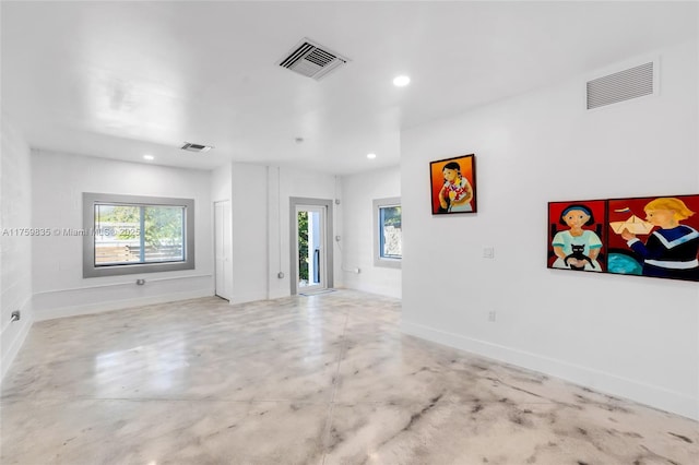 spare room with recessed lighting, visible vents, concrete floors, and baseboards