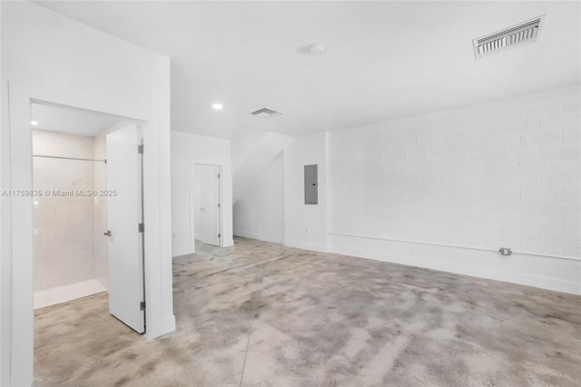 unfurnished room featuring electric panel, visible vents, and concrete flooring