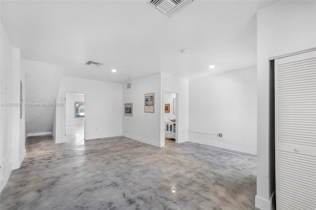 unfurnished room with recessed lighting, visible vents, and finished concrete floors