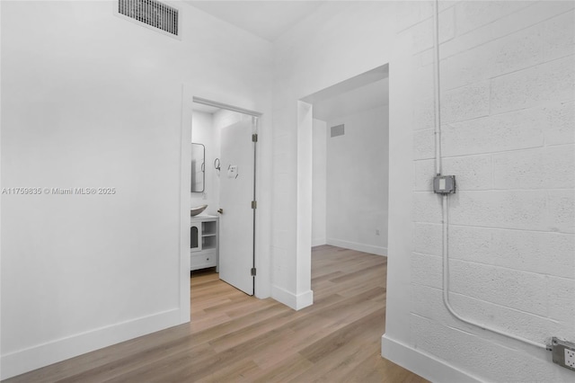 bathroom with visible vents, baseboards, and wood finished floors