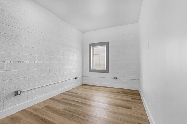 unfurnished room with wood finished floors and baseboards