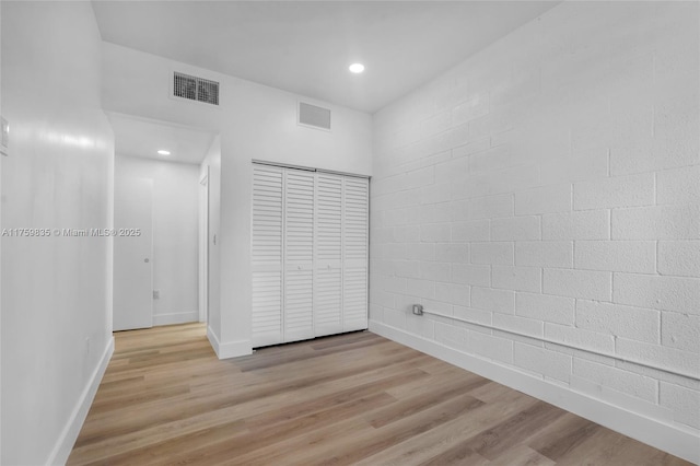 interior space featuring light wood-style flooring, recessed lighting, baseboards, and visible vents