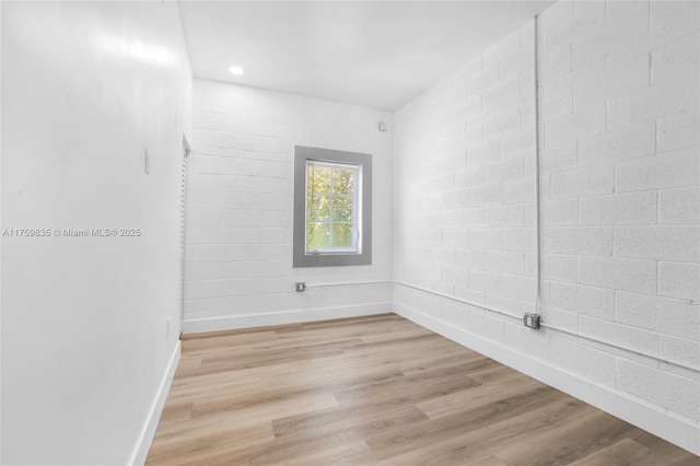 unfurnished room with recessed lighting, baseboards, and light wood-style flooring