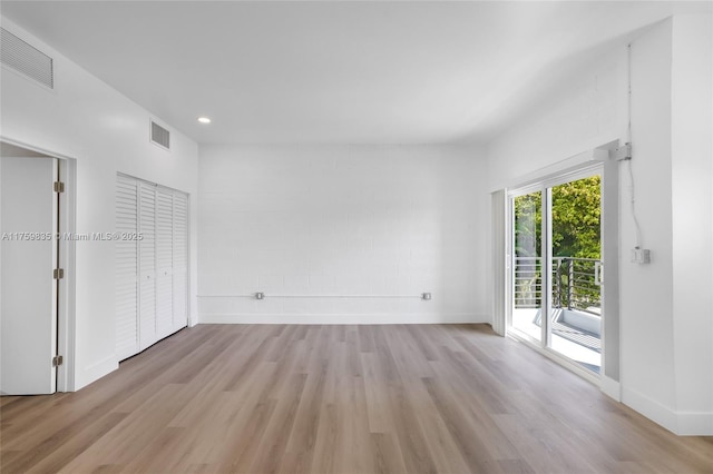 interior space with light wood-style floors, visible vents, and baseboards