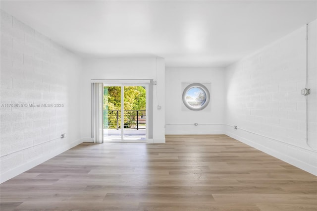 unfurnished room featuring wood finished floors and baseboards