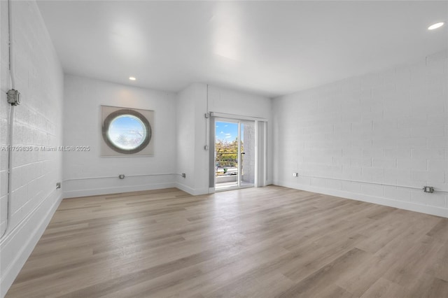 unfurnished room with recessed lighting, baseboards, and light wood-style floors