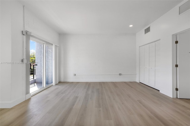 interior space with light wood-style floors, visible vents, and baseboards