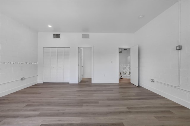 unfurnished bedroom featuring recessed lighting, visible vents, and wood finished floors