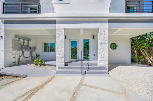 entrance to property featuring stucco siding