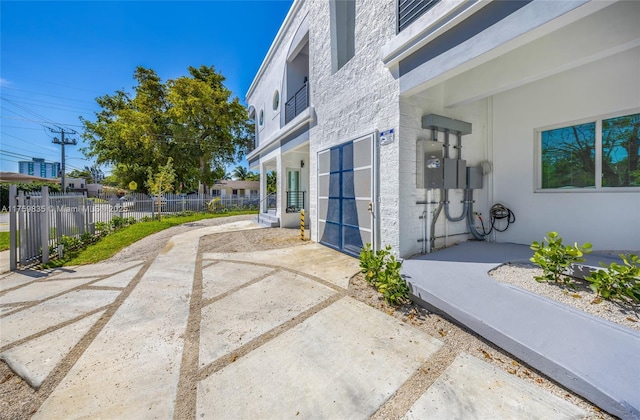 exterior space featuring stucco siding and fence