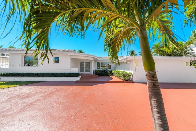1690 Daytonia Rd, Miami Beach, FL 33141 - view of front of home with french doors and stucco siding