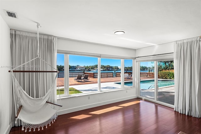 1690 Daytonia Rd, Miami Beach, FL 33141 - spare room with wood finished floors, baseboards, and a water view
