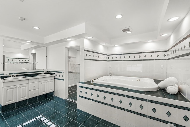 1690 Daytonia Rd, Miami Beach, FL 33141 - full bath featuring a garden tub, double vanity, tile patterned flooring, recessed lighting, and tile walls
