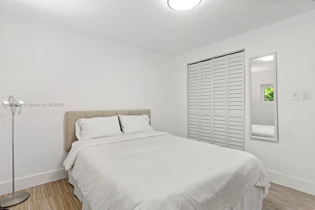 1690 Daytonia Rd, Miami Beach, FL 33141 - bedroom featuring baseboards, wood finished floors, and a closet