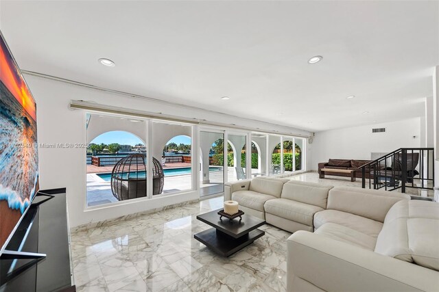 1690 Daytonia Rd, Miami Beach, FL 33141 - living area featuring marble tiled floors, healthy amount of natural light, and recessed lighting