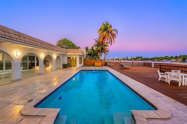 1690 Daytonia Rd, Miami Beach, FL 33141 - pool at dusk featuring a deck and a patio area