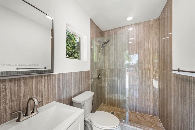 1690 Daytonia Rd, Miami Beach, FL 33141 - bathroom featuring tiled shower, toilet, tile walls, and vanity