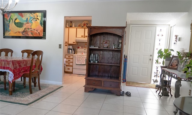 dining room featuring light tile patterned floors, baseboards, and a notable chandelier