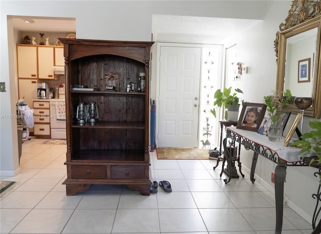 foyer featuring light tile patterned floors