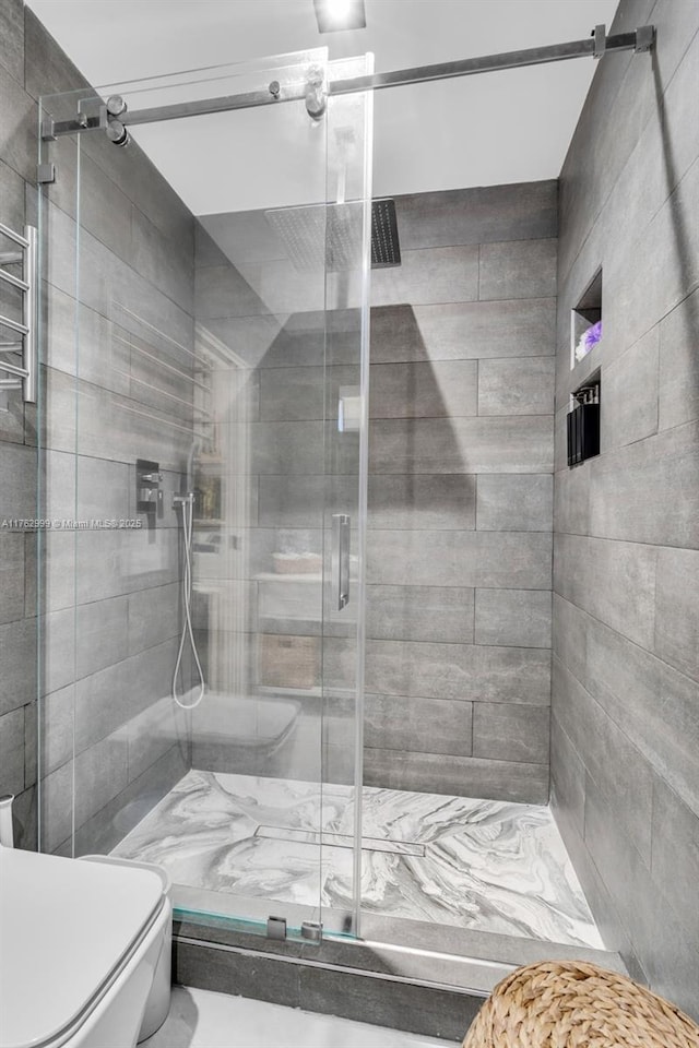 bathroom featuring a shower stall and toilet