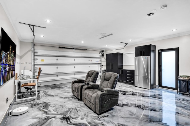 garage with recessed lighting and freestanding refrigerator