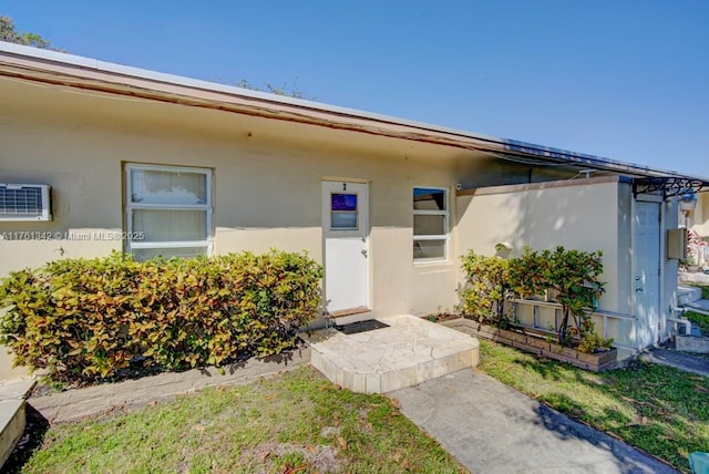 property entrance with stucco siding