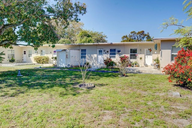 rear view of house with a yard