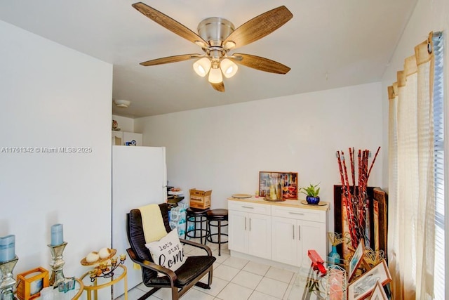 living area with light tile patterned flooring and ceiling fan