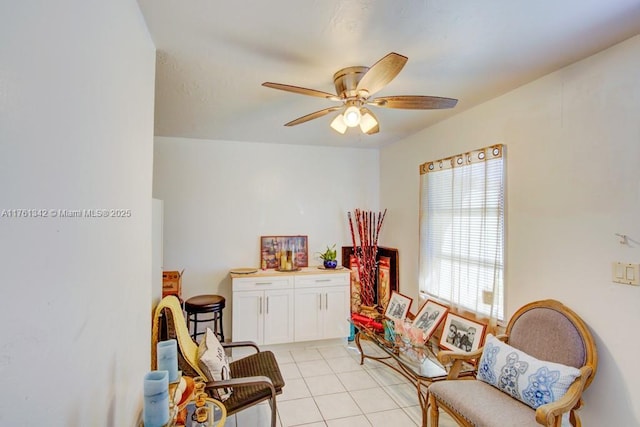 sitting room featuring light tile patterned flooring and a ceiling fan