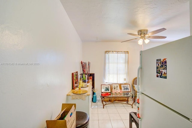 interior space with light tile patterned floors and a ceiling fan