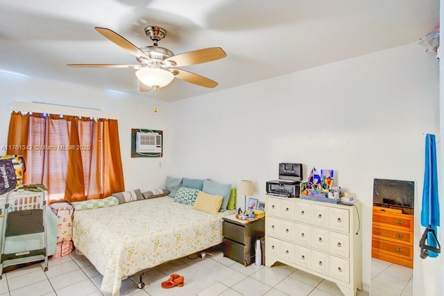 bedroom with light tile patterned floors, a wall mounted air conditioner, and a ceiling fan