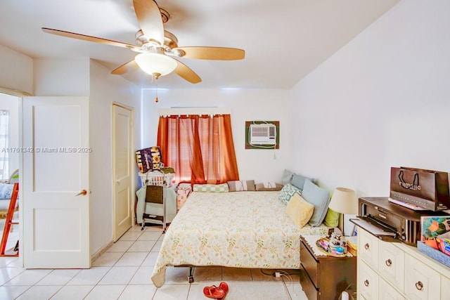 bedroom featuring light tile patterned floors, a ceiling fan, and a wall mounted air conditioner